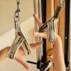ELEMENTS® Hand Y Loops in Mirage Gold shown in use on the hands on a GYROTONIC® tower